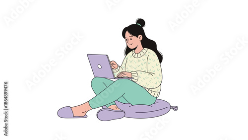 Young woman sitting on a cushion working on her laptop in a relaxed casual setting