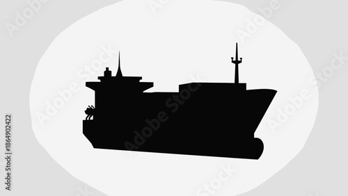 Silhouette of a large cargo ship sailing on the water.