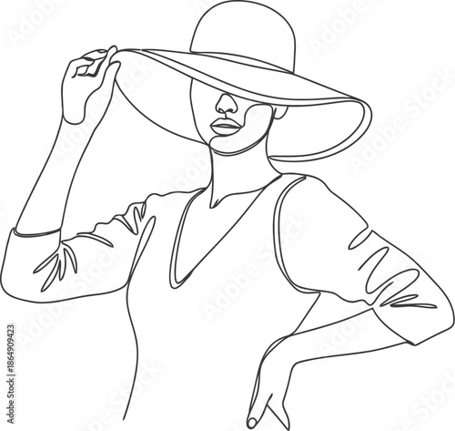 Elegant woman in wide brim hat adjusting her sun hat