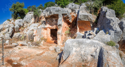 The ancient Lycian rock tombs of Demre (Myra) are carved into the red cliffs: facades with Doric columns and pilasters over terraces, a classic symbol of Lycian culture in Turkey