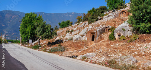 The ancient Lycian rock tombs of Demre (Myra) are carved into the red cliffs: facades with Doric columns and pilasters over terraces, a classic symbol of Lycian culture in Turkey