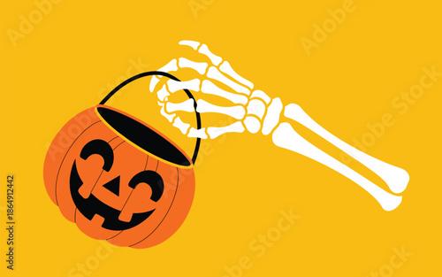 Skeleton hand holding a pumpkin bucket against a bright yellow background