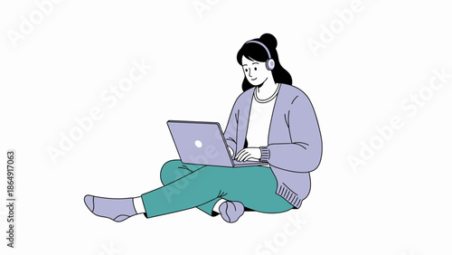 Young woman sitting cross-legged while working on a laptop with headphones enjoying music or a video