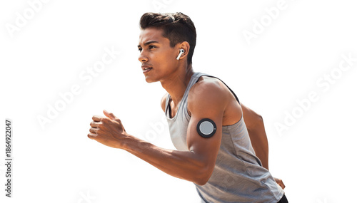 Glucose monitor patch worn by an active person jogging outdoors illustrating the integration of health tech and fitness lifestyle in natural lighting. © Justlight