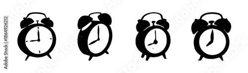 Set of four black silhouette analog alarm clocks on white background