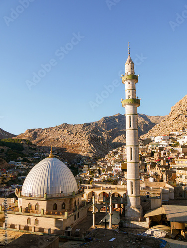 Great Mosque of Akre, Iraqi Kurdistan and the city in the background, during sunset