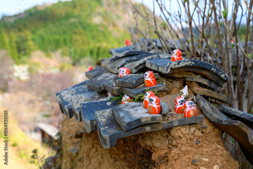 Daruma doll with Japanese character (Kanji) meaning 'Victory' in Katsuo-ji temple. Temple of Daruma Dolls, Famous travel destination for sightseeing Kansai.