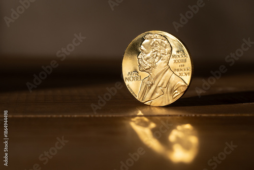 Nobel laureate medal on a wooden surface