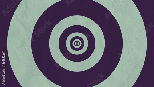 Retro concentric circles in purple and light green, creating an optical illusion of depth and movement.