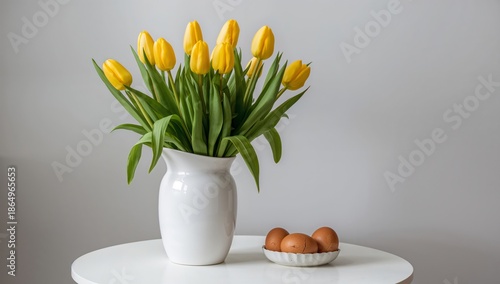 Yellow Tulips in a White Vase With Eggs on a Plate on a Table