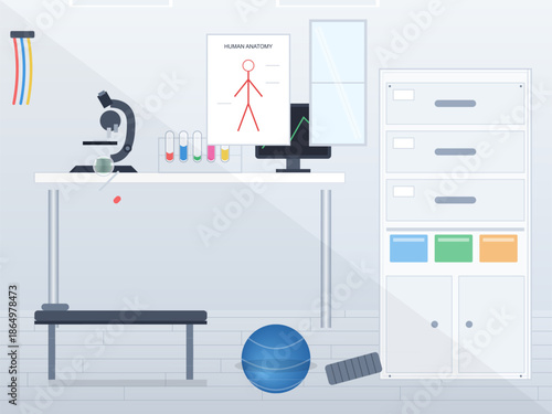 Work space with microscope, human anatomy chart, lab equipment, and exercise ball in a science room