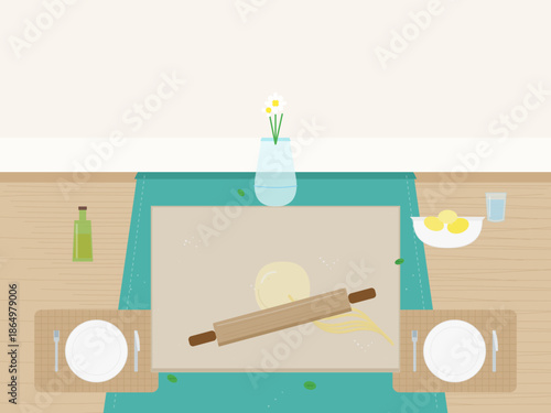 Rolling dough on a kitchen table with lemons and water nearby in a bright and simple setting