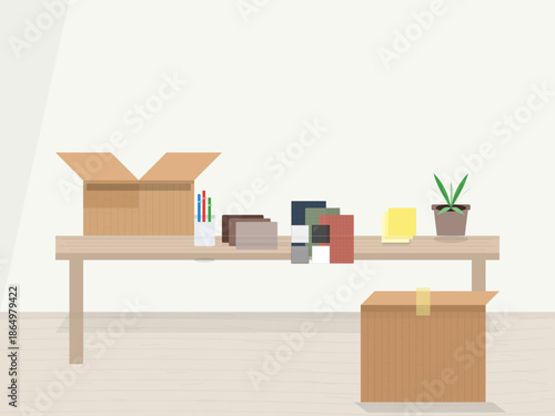 Desk with boxes, stationery, and a plant during an organizing activity at a home office