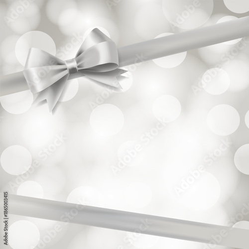 Elegant silver ribbon with a decorative bow on a soft white bokeh background. Minimal, festive design suitable for holidays, weddings, luxury branding, gift wrapping, invitations