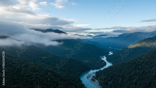 Aerial view of a winding river valley with mountains