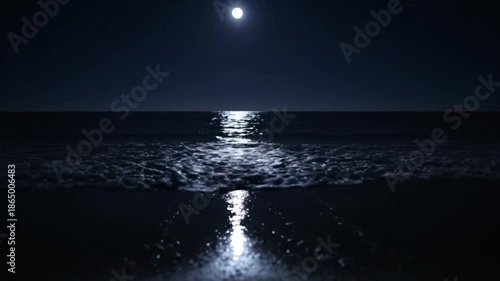 Ocean waves under the bright moon at night