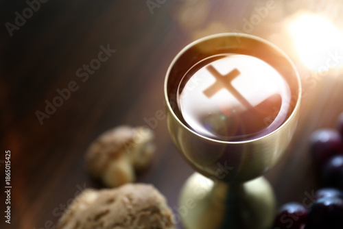 The Holy Communion bread and wine symbolizing the holy blood and body of Jesus Christ, the cross, and the Last Supper background
