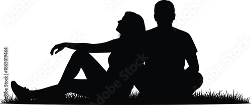Silhouette of a young romantic couple sitting together on the grass in a field, enjoying a peaceful moment during summer vacation