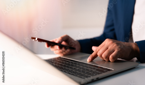 Close-up A Man typing laptop computer communicates on internet technology on office desk. Workplace, Businessman professional working on new job project. Business technology concept.