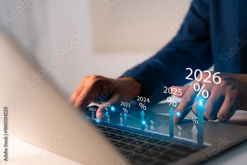 New Year 2026 Business start-up to goals, A businessman touches taps start-up button 2025 to 2026 for New Year 2026, sets goals, for develops strategies to achieve better results success in the future