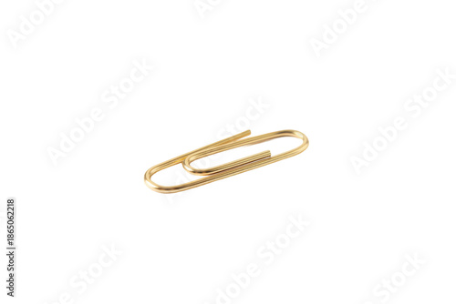 A Gold Paperclip Resting on a Neutral Surface Creating a Simple Minimalist Composition