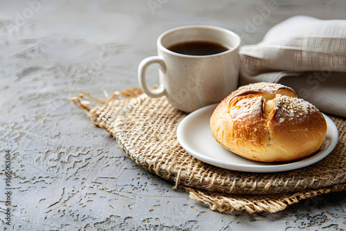 Simple Breakfast with Coffee and Fresh Bread Roll on Rustic Table