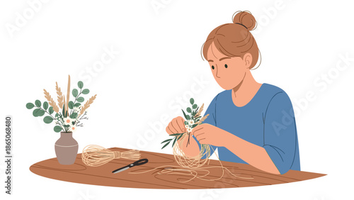 Young woman focused on crafting a delicate floral arrangement, wrapping small sprigs of leaves and flowers with twine at a wooden table, showcasing a creative hobby.
