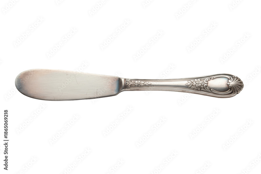 Fototapeta premium Elegant Butter Knife with Floral Details on a Neutral Surface for Culinary Purpose