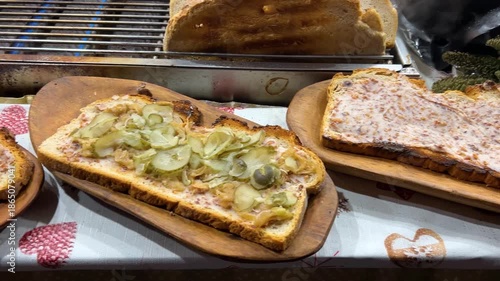 Polish zapiekanka at the Krakow Christmas market, Poland. A traditional Polish hot sandwich with cheese and filling. A variety of flavors.