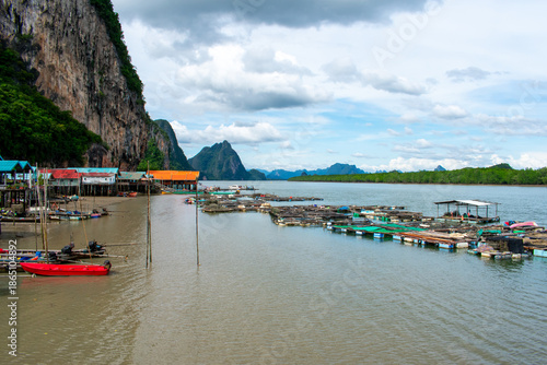 Koh Panyi floating Muslim village in Thailand. Boats and limestone rock formations on Andaman Sea, Phi Phi islands 
