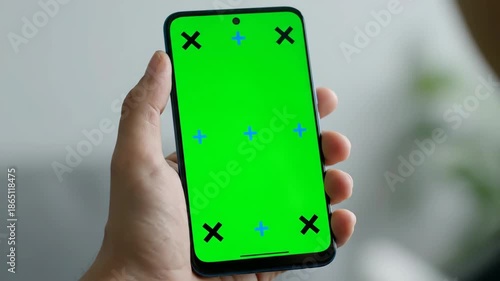 Smartphone with Green Screen in Hand for Mockup and Design