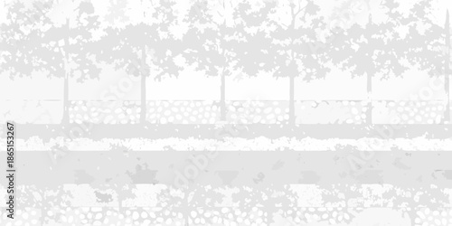 A grayscale view of a road bordered by trees and a fence