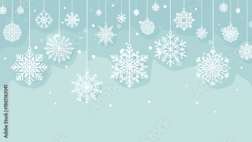 Soft blue winter background decorated with various hanging snowflake ornaments and falling white snow for a festive holiday atmosphere.