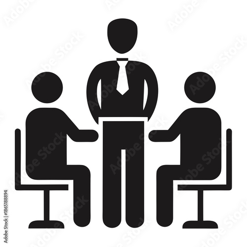 Title: Three people sitting around a table with a laptop in the center, one person in a suit and tie