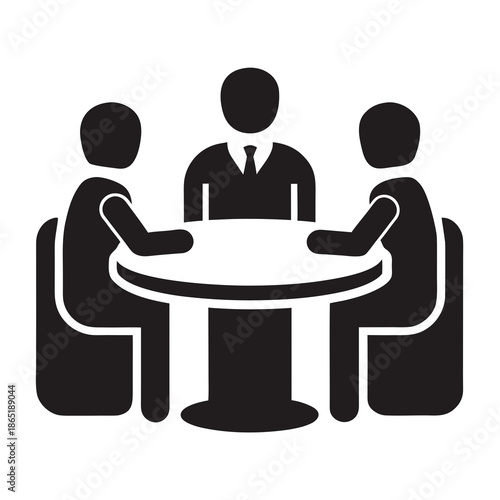 Title: Three people sitting around a table with one person in a suit and tie in the middle