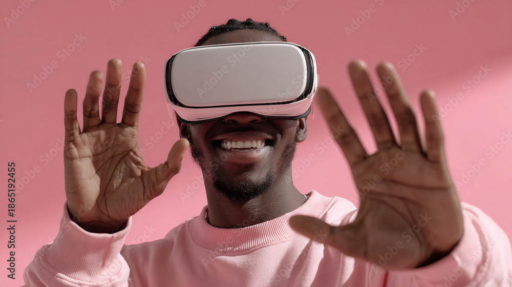 Naklejka premium Smiling man in VR headset with hands raised. Virtual reality fun concept.