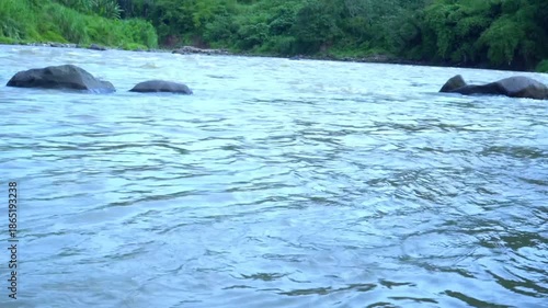 Wallpaper Mural Morning atmosphere along the Cisadane River, with calm flowing water, soft sunlight, and a peaceful riverside environment that reflects daily life, nature, and urban landscape harmony Torontodigital.ca