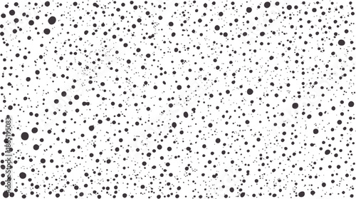 Monochrome abstract inkblot pattern with scattered dots and splatters