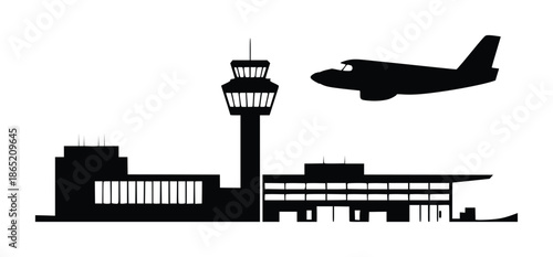 Black silhouette of an airplane flying near an airport control tower and terminal building