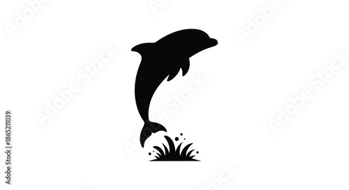 A striking black silhouette of a leaping dolphin above waving grass demonstrating marine life beauty silhouette