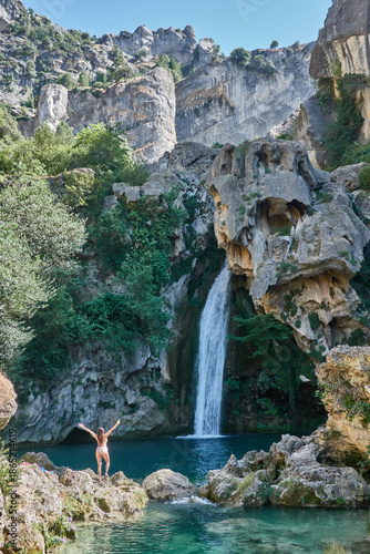 Картината върху платно Young woman in bikini enjoying the crystal clear waters of La Calavera waterfall