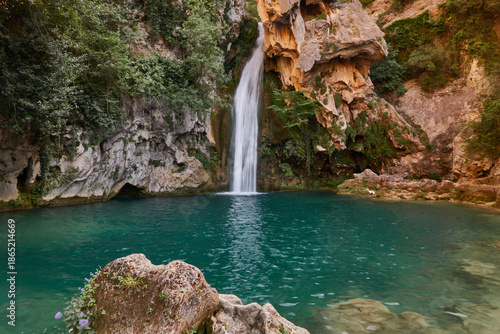 Bild auf Leinwand Young woman in bikini enjoying the crystal clear waters of La Calavera waterfall
