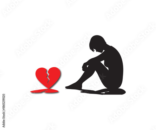 Silhouette of a grieving person sitting near a broken heart shape
