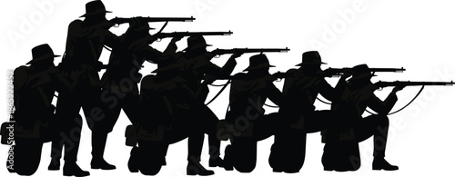 Group silhouette of historical soldiers in uniform kneeling and standing while aiming rifles during a battle reenactment or military conflict