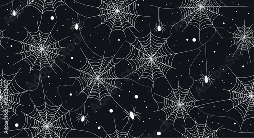 Spooky seamless pattern of white spider webs and small hanging spiders with tiny dots scattered across a dark black background surface.