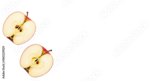 Two impeccably cut red apple slices with vibrant skin, pale flesh, and seeds, flat lay on a transparent background with copy space. Concept of natural well-being and clean eating