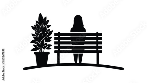 A solitary figure sitting on a park bench near a potted plant