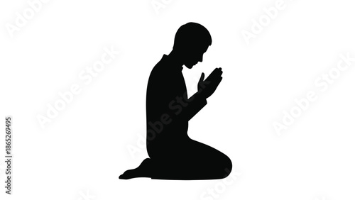 A silhouette of a person kneeling in prayer hands clasped together