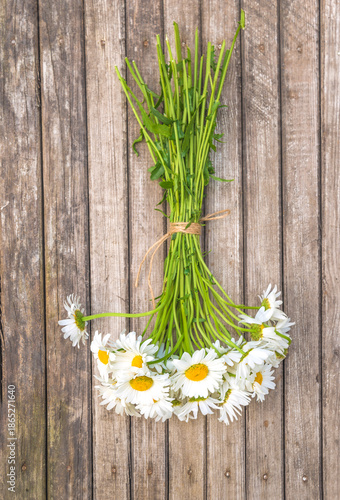 Bouquet of white daisy (marguerite) flowers on a old rustic wooden background