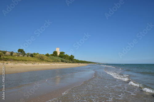 The sandy beach of Pineto (Italy) With the famous tower castle called Torre di Celano. 